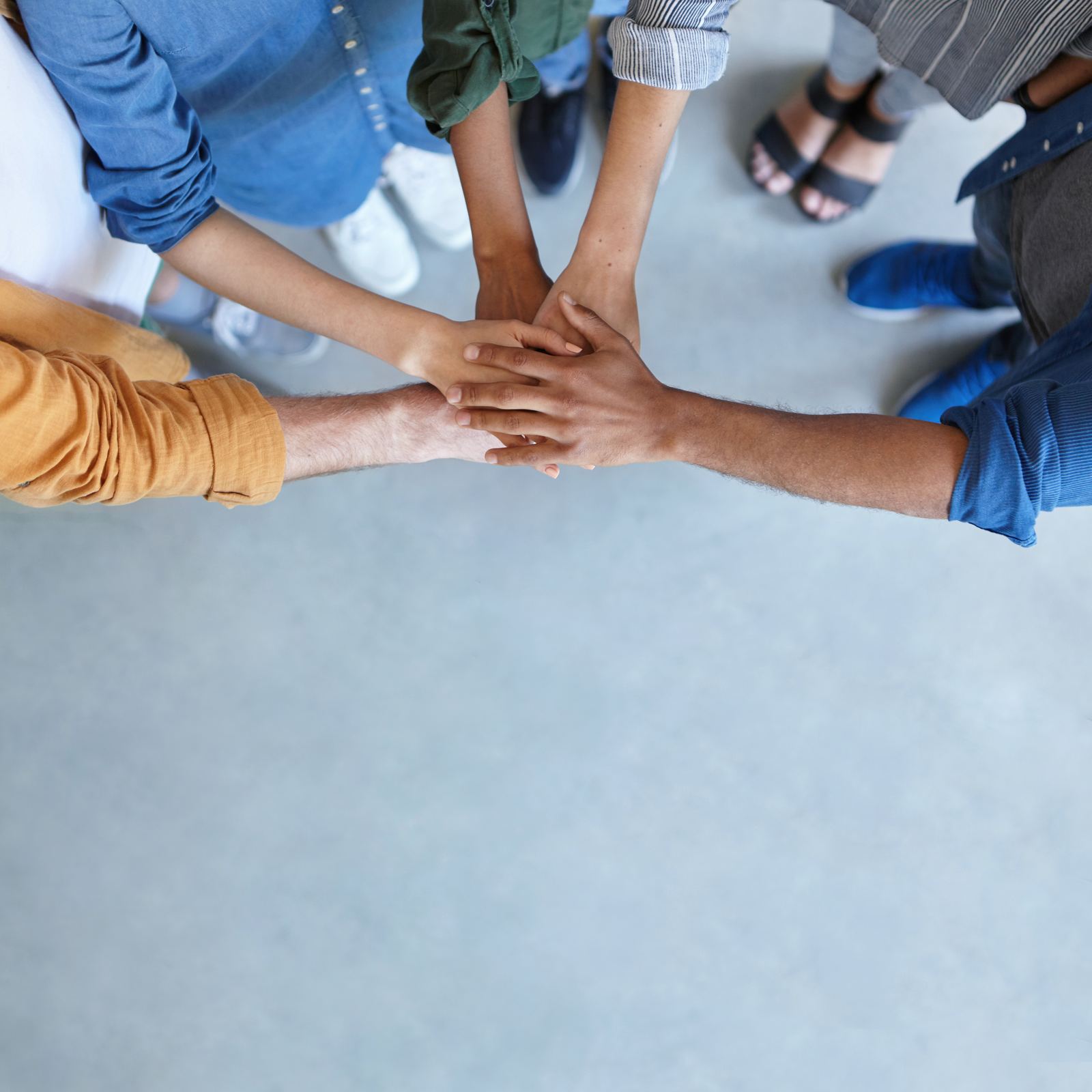 Team members joining hands