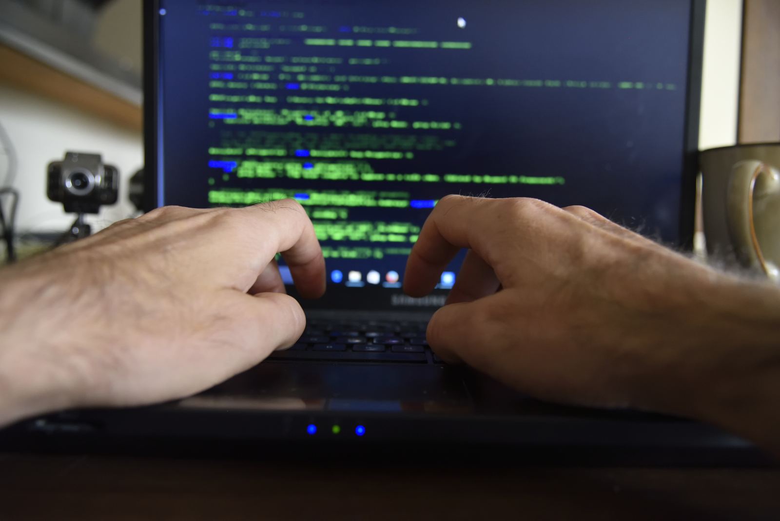 Engineer writing code on a laptop